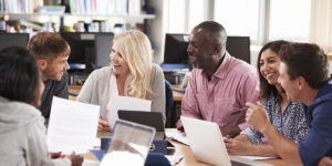 Groupe d’adultes en session de travail dans une bibliothèque.